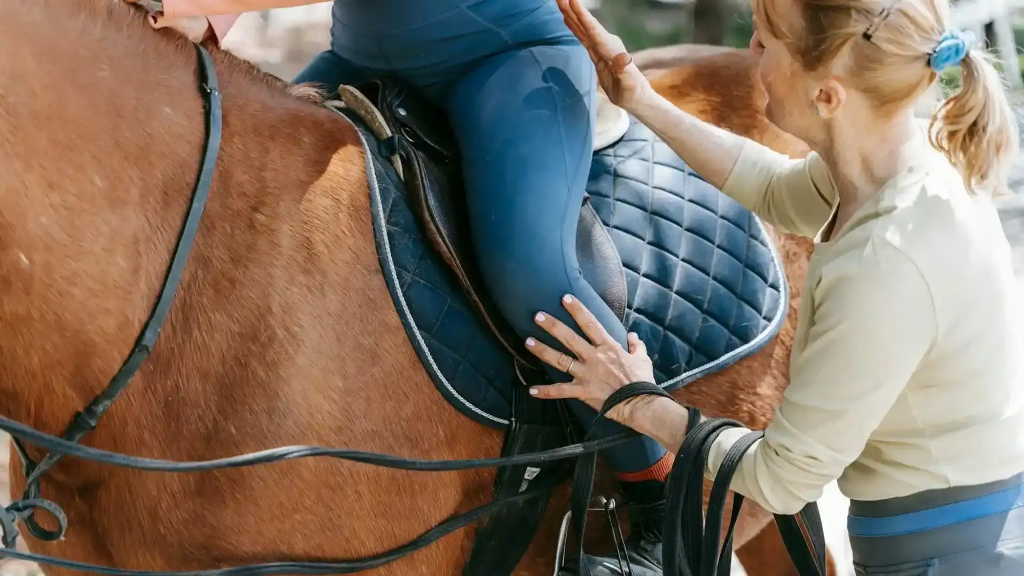 Instructor teaching a horse riding lesson in San Diego